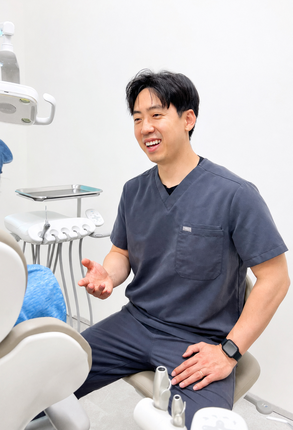 Dr. Nam speaking with a patient in a Broadview Dental treatment room
