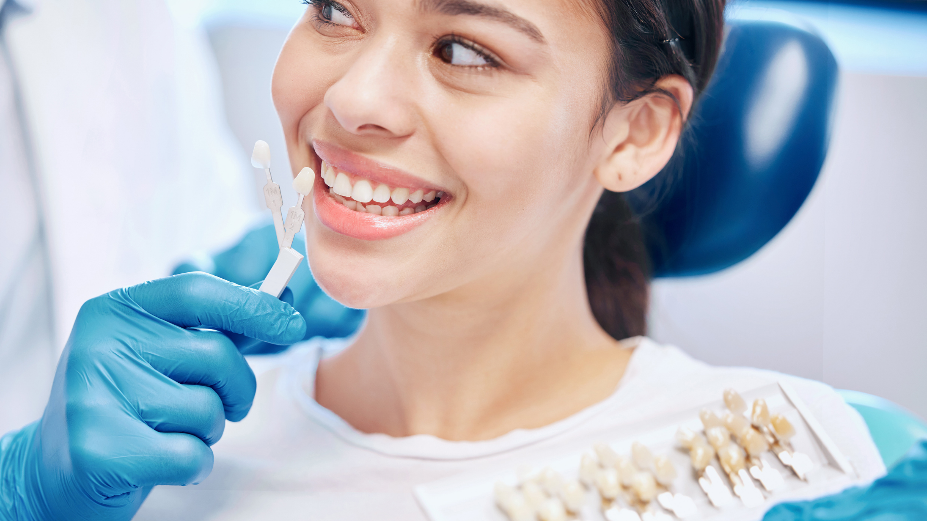 A dentist reviewing dental X-rays for restorative treatment planning.